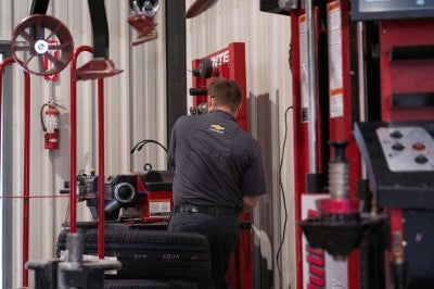 Karl Chevrolet of Webster City technician performing service on a vehicle in the shop